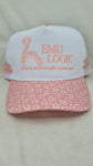 White cap with floral pink brim and 'EMU LOGIC' branding on a light gray background