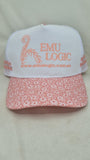 White cap with floral pink brim and 'EMU LOGIC' branding on a light gray background